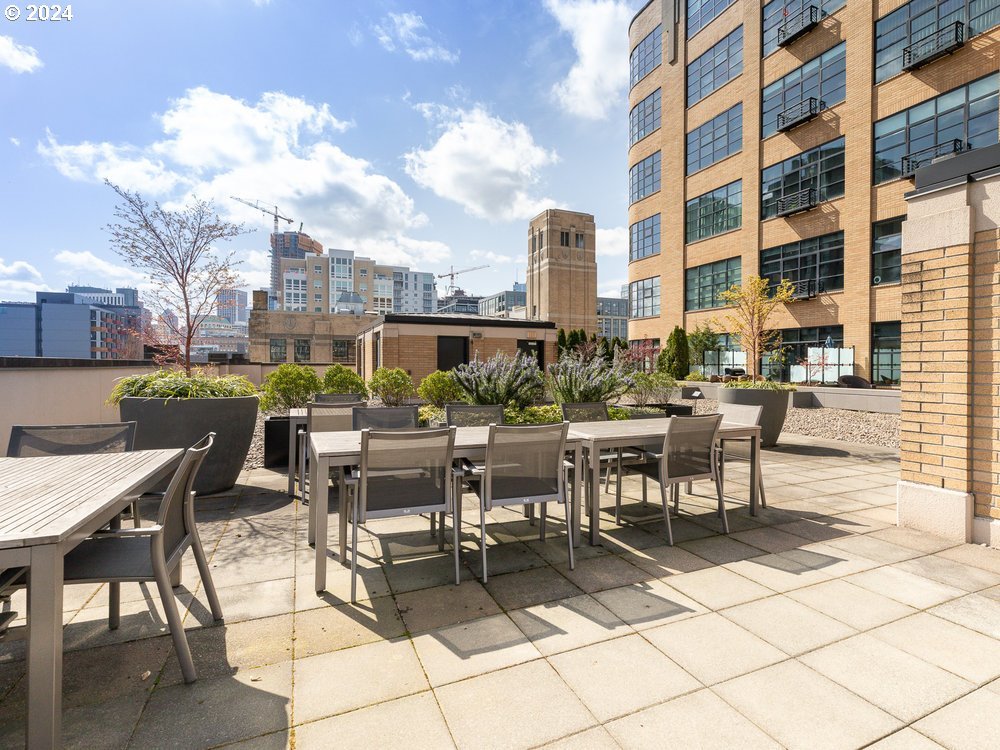 Gregory Condos rooftop deck with city views and outdoor seating